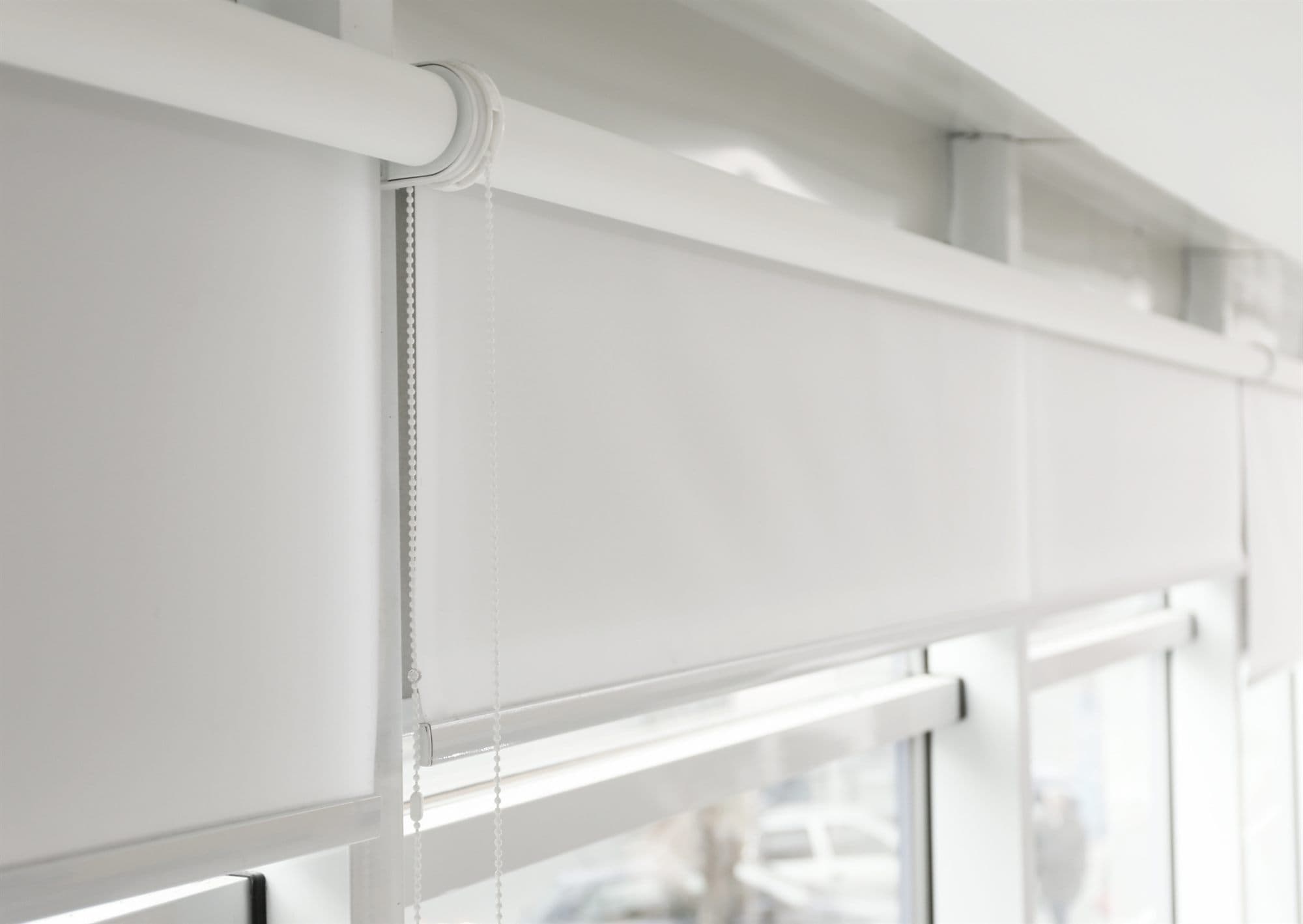 White roller blinds in a commercial office after in-place cleaning