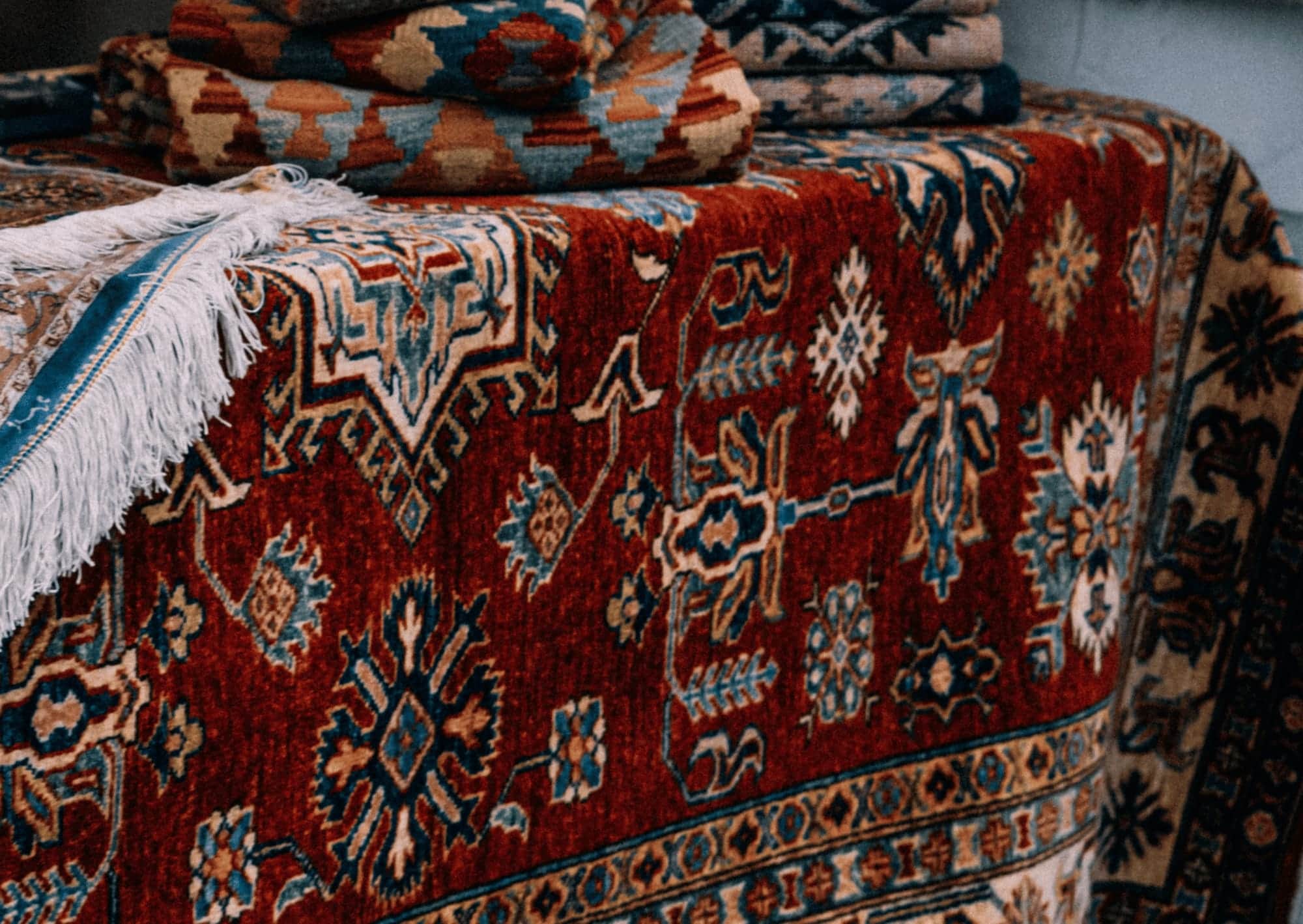 Stack of freshly cleaned Persian rugs, hand-washed by our rug specialists in Johannesburg