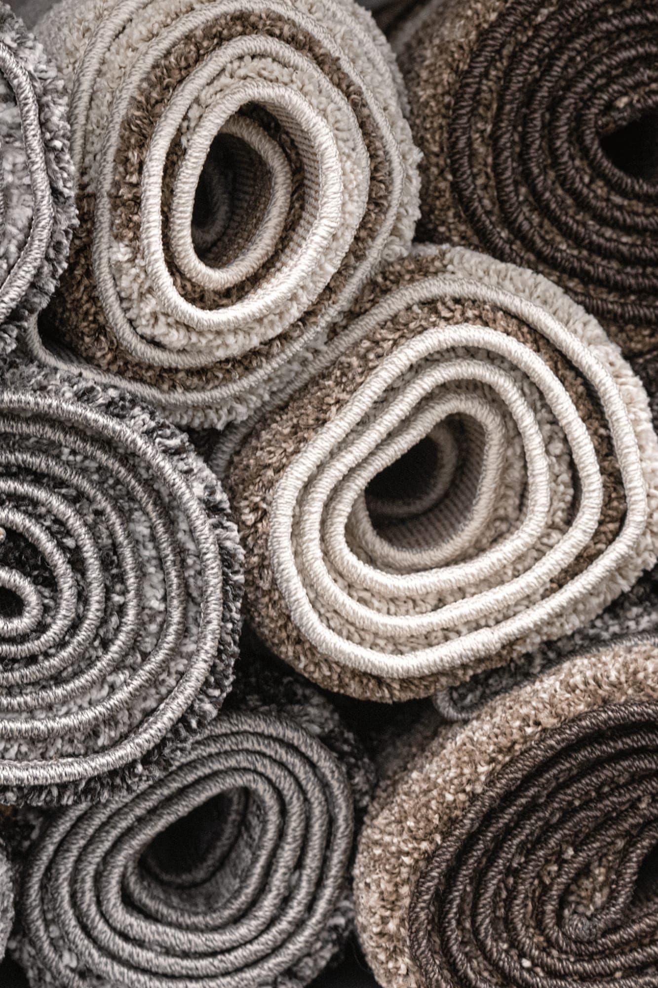 Everyday synthetic and shaggy rugs rolled up, ready for collection and cleaning by The Carpet Guys in Johannesburg